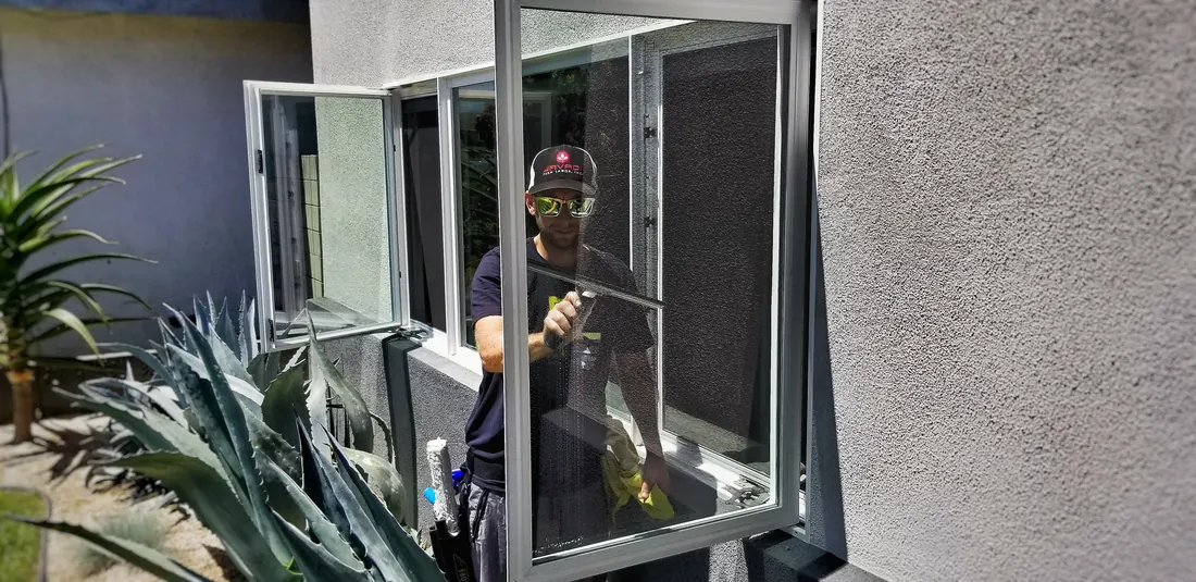 EuroPRO technician cleaning a home's windows